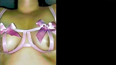 Busty Latina babe's huge tits and nipples exposed in sheer pink bow lingerie bra