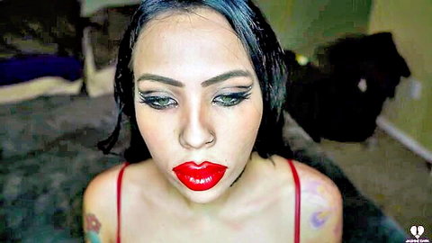 Latina brunette with wet hair puckers plump red lips in teasing blowjob pose