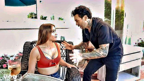 Tattooed guy roughly grabs skinny brunette teen's face as she sits in red bikini top flashing cleavage and tattoos