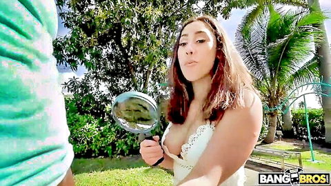 Kira Perez in sexy lace top holding magnifying glass outdoors, BangBros