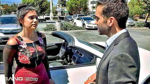 Violet Starr in sexy red floral dress at car, negotiating deal