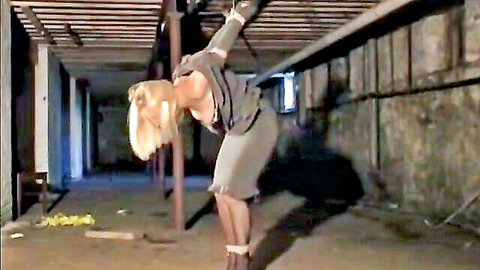 Blonde mature skinny woman bound suspended topless exposing medium tits in BDSM rope bondage stockings