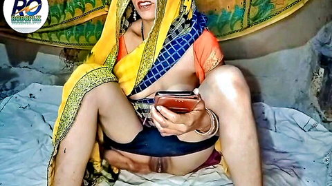 Desi MILF in yellow saree spreads legs exposing hairy pussy holding phone selfie