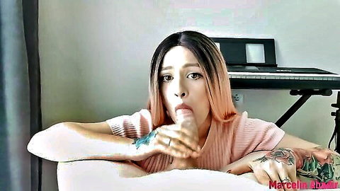 Tattooed pink-haired beauty in sweater sticks out wet tongue teasing cock suck POV