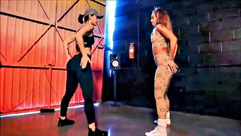 Two babes twerking big asses in tight leggings, grinding seductively side by side