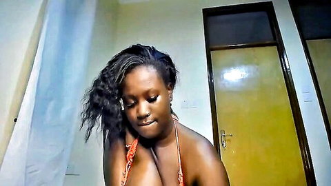 Hot ebony beauty with big tits in orange bikini teasing