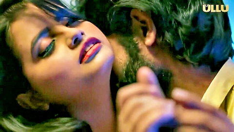 Passionate Indian woman with red lips kissing bearded man intensely in steamy embrace