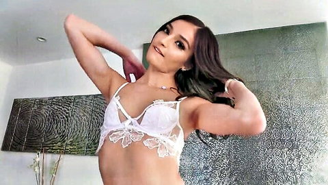 Emily Willis posing in sexy white lace lingerie, arms raised seductively