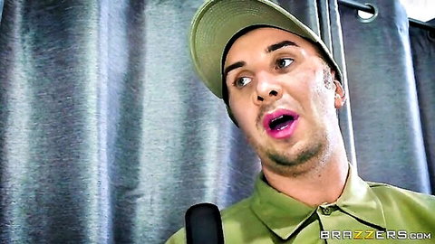 Man in green uniform cap moaning with open mouth holding microphone in Brazzers scene