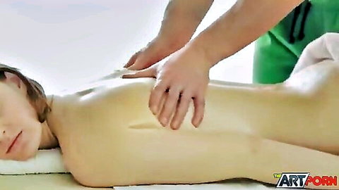 Nude white babe lies face down as masseur gropes her bare ass during erotic massage