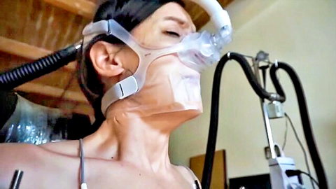 Mature skinny brunette with small tits exposed in tight BDSM breathing mask bondage slave scene