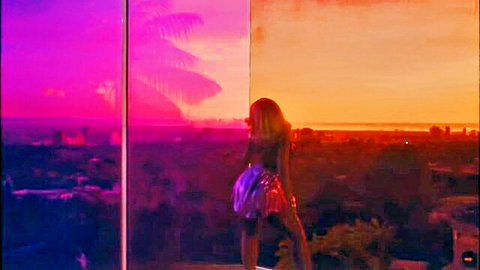 Doja Cat in shiny mini dress on sunset rooftop, solo view