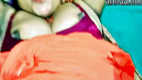 Indian Desi woman with big exposed tits lying in bed, cleavage tease