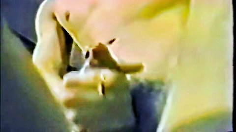 Vintage close-up of pale woman deepthroating thick cock with hands gripping.
