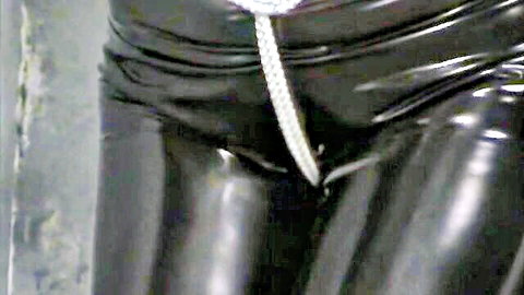 Ashley Renee in tight PVC catsuit, bound with beaded chain, BDSM crotch view