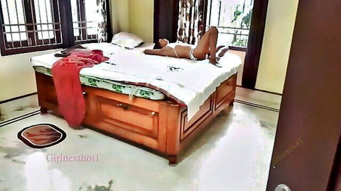 Sexy Indian woman in white lingerie posing seductively on bed