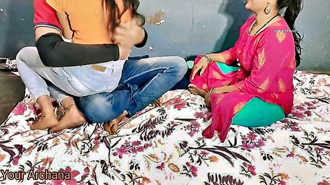 Indian stepfather embraces stepdaughter on bed with mother watching