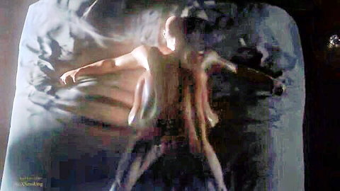 Blurry naked pale man spread eagle on bed with tentacle arms