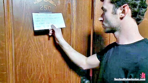 Man slips note under wooden hotel room 250 door in Sex and Submission BDSM scene