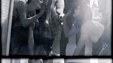 Black and white intimate group scene from Arctic Monkeys Arabella video with nude shoulders