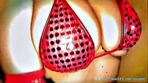 Burlesque girl in red cutout bikini top, big cleavage on solo webcam