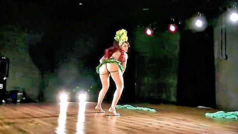 Ladybird redhead in sexy green skirt bending over, teasing big ass on stage