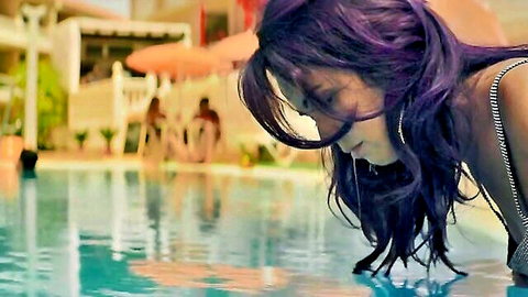 Veronica Sanchez in striped bikini leaning over poolside, Sky Rojo scene