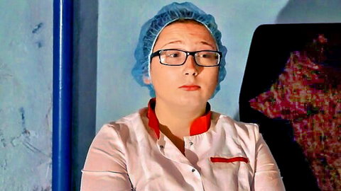 Serious nurse in white uniform, glasses and blue cap, medical roleplay tease