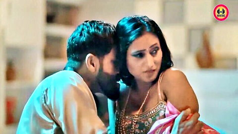 Seductive Indian couple in saree embrace, man kissing woman's neck in hot web series