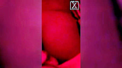 Big black ass close-up in red lighting, teasing with curves