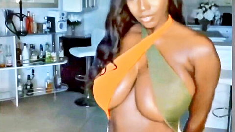Ellie The Empress black YouTuber in revealing orange strap top showing huge cleavage