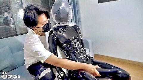 Asian man groping latex-encased woman in full body suit and BDSM headgear