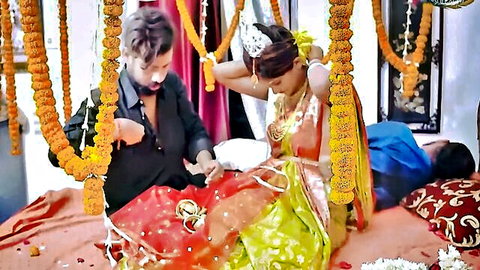 Indian newlywed wife in red saree with lover adjusting blouse in front of sleeping husband