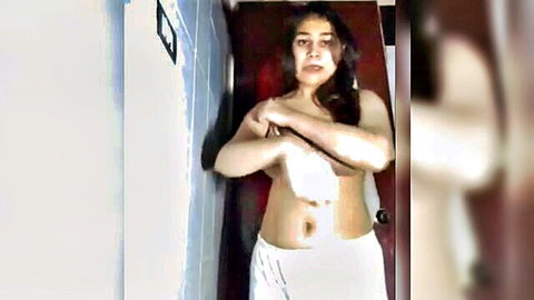 Cute Indian girl undressing, covering big boobs in amateur video