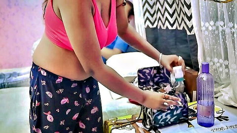 Indian desi girlfriend in pink crop top and floral pajamas bending over with boyfriend