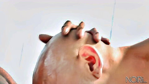 Hands gripping bald man's shaved head tightly in intense gay deep throat action