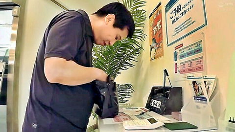 Japanese man at bank counter in office shirt, leaning with bag, JAV bank fantasy setup