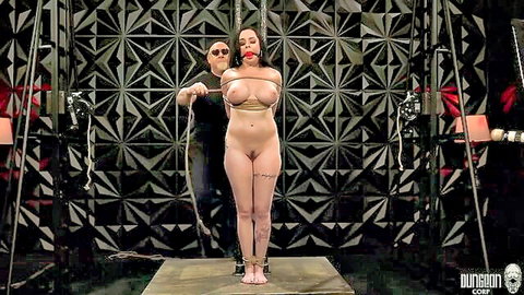 Bound big-titted woman gagged and roped in intense BDSM suspension scene