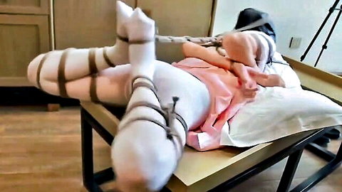 Hooded Chinese woman hogtied in pink dress and white stockings BDSM bondage