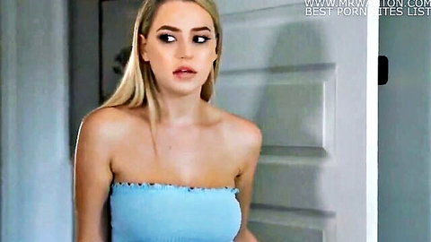 Blonde woman in light blue strapless top, teasing doorway pose