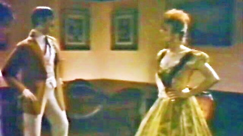Peter North and Debi Diamond in vintage gown and vest scene from Night At The Waxwork