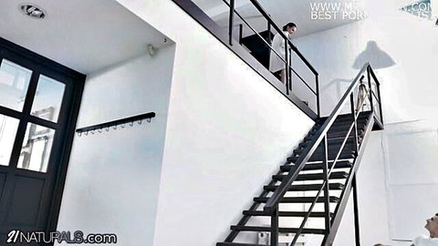 Slim brunette in white lingerie on stairs with Charlie Dean, teasing pose