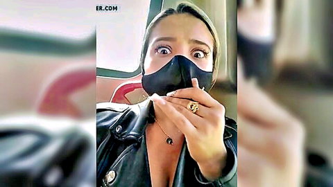 Masked Asian cutie in open leather jacket showing cleavage selfie