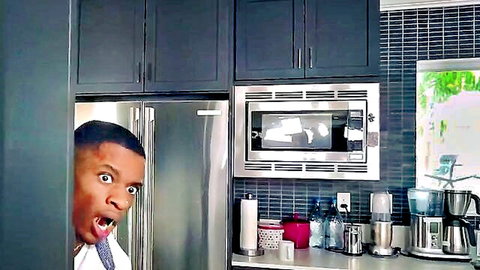 Excited black stepdad peeking from fridge in kitchen, taboo family scene setup