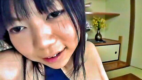 Cute Asian teen beauty smiling close-up in dark top, teasing vibe