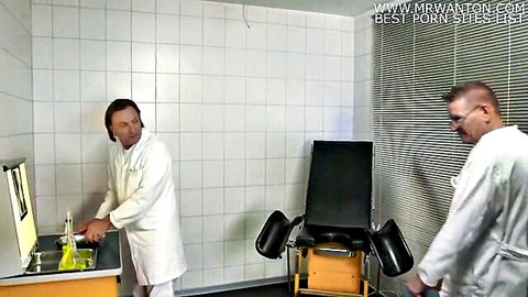 Two male doctors in white coats preparing for gyno exam in clinic