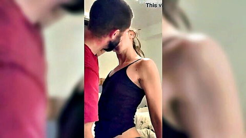 Man kissing blonde MILF from behind in black camisole