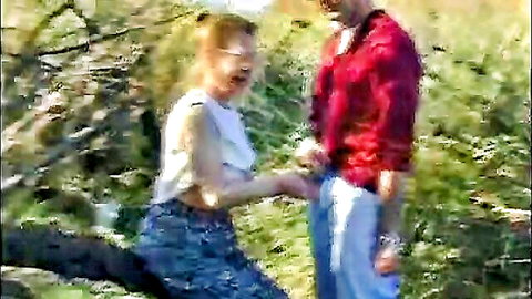 Blonde woman kneeling intimately with man in outdoor field, Costa Del Screw thumbnail