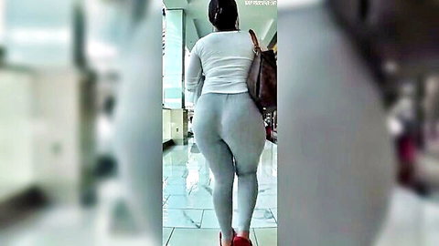Curvy ebony woman in tight gray leggings jiggling big ass while walking