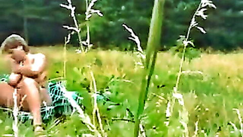 Blonde BBW MILF with large breasts nude in outdoor field